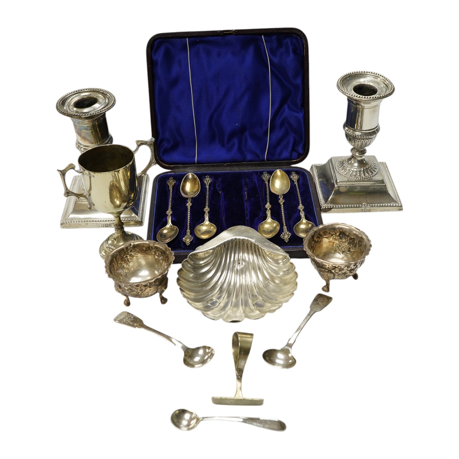 A pair of late Victorian silver dwarf candlesticks, Martin, Hall & Co, Sheffield, 1898, 11.4cm, weighted, a small pair of Irish silver salts, a silver butter shell and six other items including plated ware. Condition - p